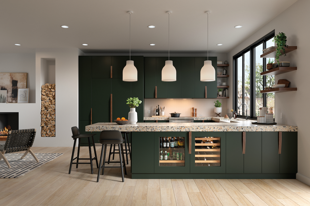 Luxury kitchen interior with deep green cabinetry, pendant lighting and a fireplace